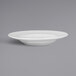 A close-up of a RAK Porcelain white deep plate with an embossed rim.