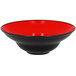 A red porcelain plate with a black rim.