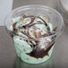 A WNA Comet clear plastic lid on a cup of chocolate and mint ice cream.