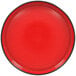 A white porcelain plate with a red center and black rim.