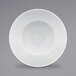 A white RAK Porcelain plate with a textured pattern and a wide rim.