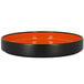A black and orange RAK Porcelain deep plate with a black rim.
