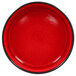 A red porcelain bowl with a black rim.