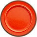 an orange plate with black rim