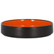 A black and orange RAK Porcelain deep plate with a black rim.