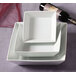 A stack of square white CAC porcelain bowls.