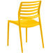 A Lancaster Table & Seating Allegro Marigold Yellow stackable resin side chair with slats and legs.