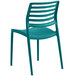 A teal stackable plastic chair with slats on the back.