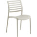 A beige plastic chair with a slatted back.
