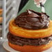 a stack of cake with chocolate frosting