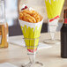 A Carnival King cardboard fry cone filled with French fries on a table in a restaurant.