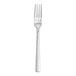 A silver Fortessa Spada table fork with a white background.