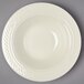 A close up of a Homer Laughlin ivory china bowl with a pattern on it.