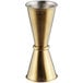 A gold metal measuring cup with a silver handle.