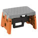 A black, grey, and orange Cosco molded plastic step stool.