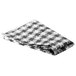 A folded black and white checkered vinyl table cover.