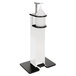 A white freestanding hand sanitizing station with a white bottle on top and a black ring around it.