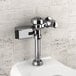 A close up of a Sloan chrome toilet flush sensor retrofit kit.