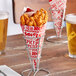 A Carnival King paper cone filled with fried food on a table.