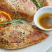 A plate of food with sauce and orange slices, a close up of a slice of orange, and a close up of a piece of meat.