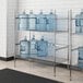 A Regency wire rack holding water jugs.