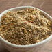 A bowl of Regal Canadian Steak Seasoning on a wooden table.