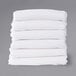 A stack of white rectangular Foundations SafeFit compact crib fitted sheets.