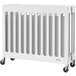 A Foundations Boutique white slatted wood folding crib with wheels.