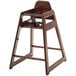 A Foundations wooden high chair with an antique cherry finish.