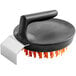 A black circular brush with orange nylon bristles and threads.