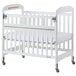 A white Foundations Serenity SafeReach wood crib with a white sheet on the mattress.