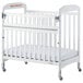 A white Foundations Serenity SafeReach wood crib with wheels and a white mattress and sheet.