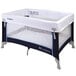 A white and blue Foundations Celebrity playard set up with mattress and cover.