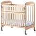 A natural wood crib with a clearview side and adjustable mattress board.