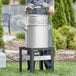 A man using a Backyard Pro aluminum seafood boiler kit.