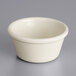 An Acopa bone white melamine ramekin on a white surface.