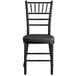 A Lancaster Table & Seating black wood Chiavari chair with black cushion.