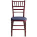 A Lancaster Table & Seating Mahogany Wood Chiavari Chair with Navy Blue Cushion.