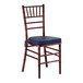 A mahogany wood Chiavari chair with a navy blue cushion.