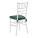 A white wood Chiavari chair with a green cushion tied to the seat.