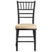 A black Lancaster Table & Seating Chiavari chair with a tan cushion.