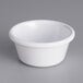 A white Acopa melamine ramekin on a gray surface.