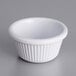 An Acopa white fluted melamine ramekin on a gray surface.