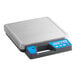 A grey digital scale with a blue screen and black buttons.