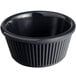 An Acopa black fluted melamine ramekin on a table.