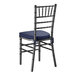 A black wood Chiavari chair with a navy blue cushion.