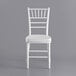 A white Lancaster Table & Seating Chiavari chair with a white cushion.