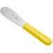 A Choice stainless steel sandwich spreader with a yellow handle.