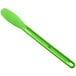 a green spoon on a white background