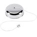 A silver metal 8' Retractable Clothesline on a table in a white room.
